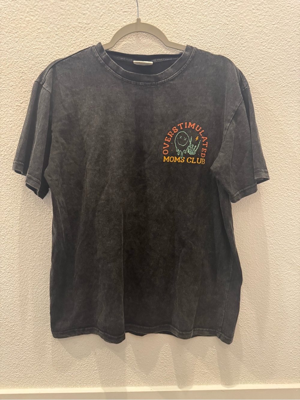 "Overstimulated Moms Club" acid-wash black graphic t-shirt